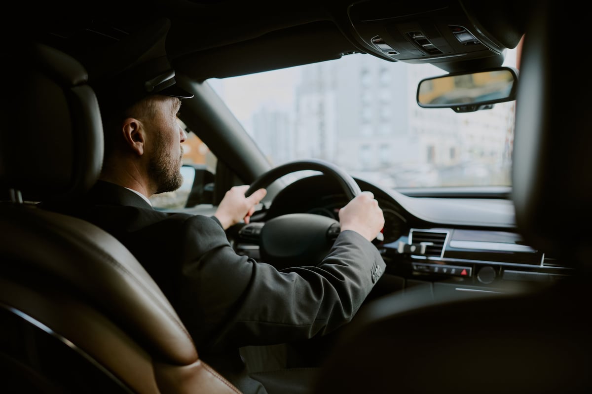 Professional driver at the wheel of a private transfer car