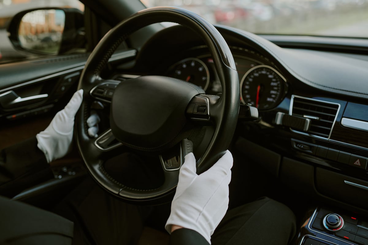 Professional driver at the wheel of a premium vehicle