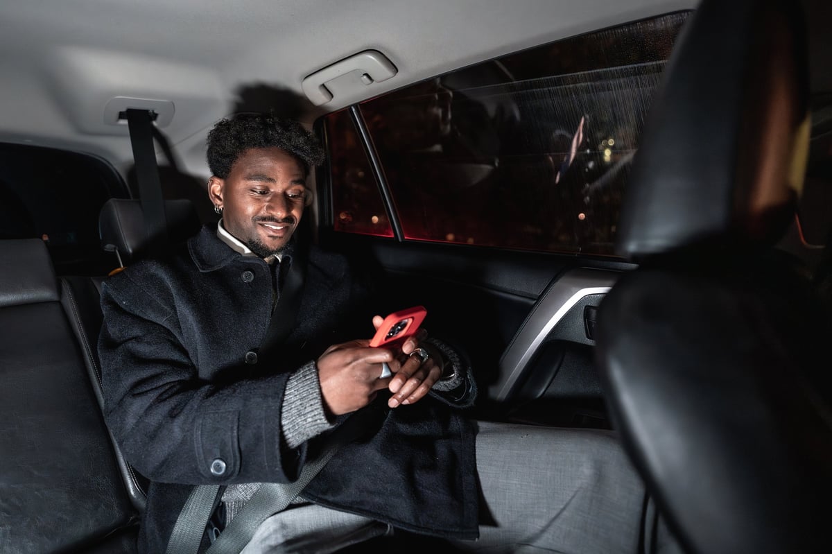 Passenger relaxing in the back of a private transfer vehicle